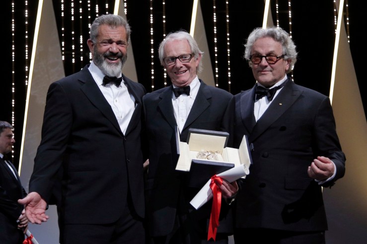 Director Ken Loach, centre, actor Mel Gibson, left and President of the Jury George Miller react after Roach is awarded the Palme d'or for the film I, Daniel Blake, during the awards ceremony at the 69th international film festival, Cannes, southern France, Sunday, May 22, 2016. (AP Photo/Thibault Camus)